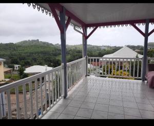 a porch of a house with a view of the mountains at Villannéva Calme et Spacieuse avec piscine in Ducos