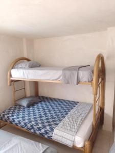 two bunk beds in a room with a mattress at Hostel Santa Marta el Rodadero in Santa Marta