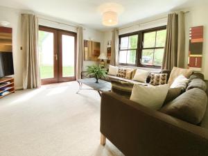 a living room with a couch and a tv at Lochindaal - Beautiful, Spacious 4 Bedroom House in Kintyre in Whitehouse