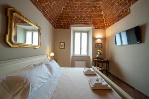 Postel nebo postele na pokoji v ubytování Cascina Baronina