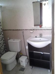 a bathroom with a sink and a toilet and a mirror at Cabañas Lunas y Soles in Potrero de los Funes