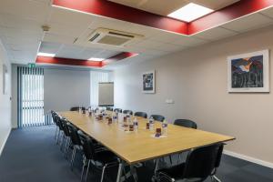 a conference room with a long table and chairs at ACE H&ocirc;tel Thionville - Porte du Luxembourg in Thionville