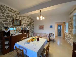 a kitchen and living room with a table with fruit on it at Asterion Bella View in Zaros