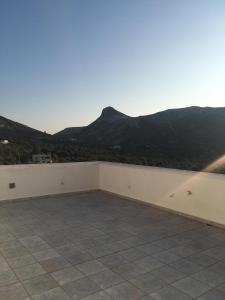 a balcony with a view of a mountain at Iliachtida apartments in Philotium