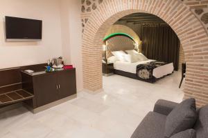 a hotel room with a bed and a tv at Pintor El Greco in Toledo