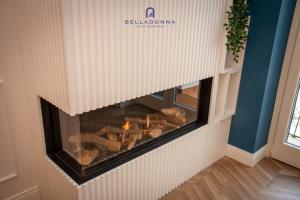 a fireplace in a room with logs in it at Belladonna Luxury Apartment in Cava deʼ Tirreni