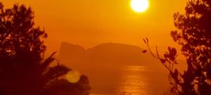 an image of the sun setting over the water at Arcamyrtus in Alghero