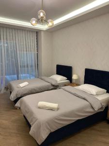a bedroom with two beds and a ceiling fan at Emela Villa in Sapanca