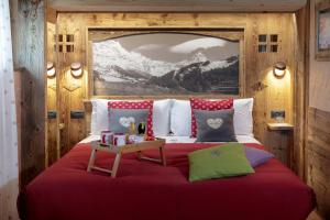 a bedroom with a bed with a table on it at Chalet Matterhorn Francois - Spa and Wellness Ski Chalet 100mt lift in Breuil-Cervinia