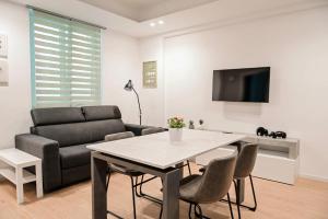 a living room with a table and a couch at HABITAT- Apartments&Rooms in Cerignola