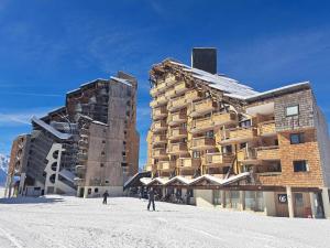 two buildings in the snow with people standing in front of them at Charmant appartement à Avoriaz pour 6 pers, avec Wi-Fi et casier à ski - FR-1-314-119 in Avoriaz