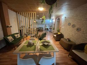 a living room with a table and chairs at CASA ARIAN in Haţeg