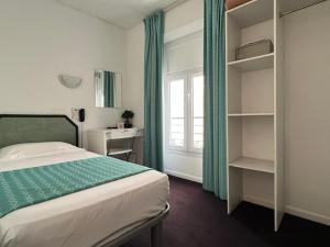 a small bedroom with a bed and a window at Little Palace in Cannes