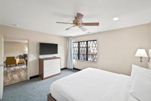 a bedroom with a bed and a flat screen tv at The English Inn of Charlottesville in Charlottesville