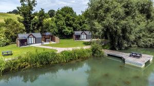 an aerial view of a holiday home next to a lake at Willow Lodge At Bridge Lake Farm & Fishery in Banbury