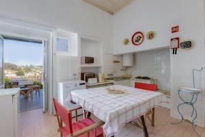 a kitchen with a table and a table and chairs at Casa Dorothea in Cercal