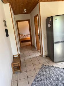 a hallway with a refrigerator and a bedroom at Ferienwohnung Derscheid in Much