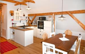a kitchen with white cabinets and a wooden table at 2 Bedroom Stunning Apartment In Mozirje in Mozirje