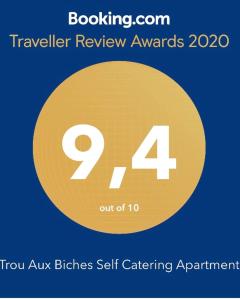 a yellow sign with the number two and four at Trou Aux Biches Self Catering Apartment in Trou aux Biches