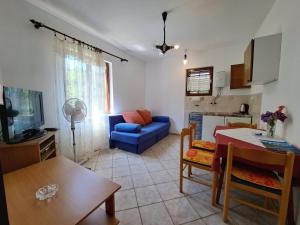 a kitchen and a living room with a blue couch at Apartments 1000 Flowers in Stari Grad +34 photos