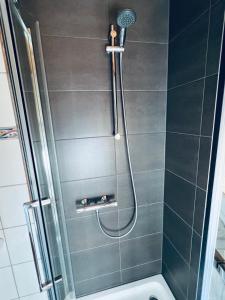 a bathroom with a shower with a shower head at Ferienwohnung Derscheid in Much