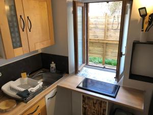 a small kitchen with a sink and a window at ORC Adventure - Les Monts du Lyonnais in Vaugneray