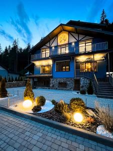 a large house with lights in front of it at Blueberryhouse in Bukovel