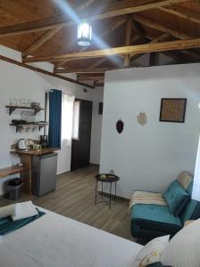 a room with a bed and a couch and a table at Orange Garden Double Rooms in Kala Nera