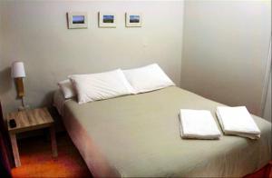 a bedroom with a bed with two towels on it at COLONIAL SAN LAZARO in Arequipa