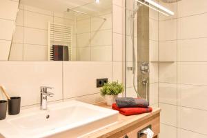 a white bathroom with a sink and a shower at Haus Franzi in Steeg