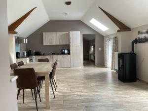 a kitchen and dining room with a table and chairs at Gîte du Pont de Bois in Thuin