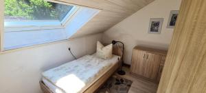 a small bedroom with a bed and a window at Haus Annemarie in Goldkronach