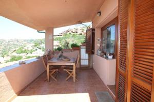 a patio with a table and chairs on a balcony at Belvedere-InfinityHolidays in Costa Paradiso