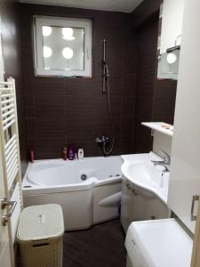 a bathroom with a bath tub and a sink at Appartment Center in Sarajevo