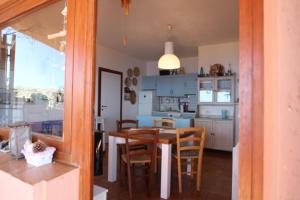 a kitchen and dining room with a table and chairs at Belvedere-InfinityHolidays in Costa Paradiso +21 photos
