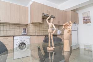 two mannequins on a glass table in a kitchen at Private room in shared flat in Nicosia