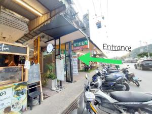 a group of motorcycles parked outside of a building at Mee Tang Nang Non in Phuket