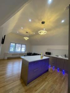 pusty pokój z kuchnią z fioletowymi szafkami w obiekcie Penthouse APT 7 w mieście Wolverhampton