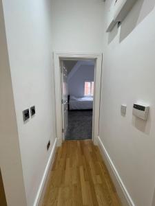 a hallway with a door leading to a bedroom at Penthouse APT 7 in Wolverhampton