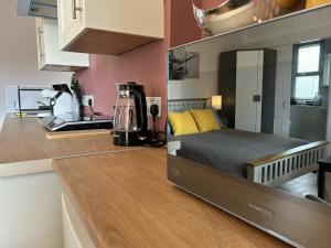 a kitchen with a bed in the middle of a room at Wells Nest in Wells