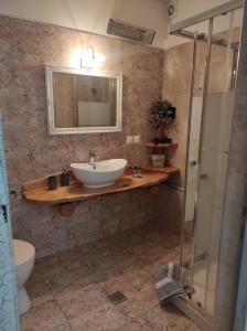 a bathroom with a sink and a mirror at Orange Garden Loft in Kala Nera +38 photos