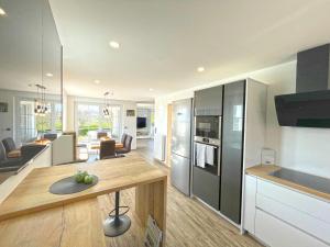 a kitchen and living room with a table in it at Chill Hill House in Sveti Martin na Muri