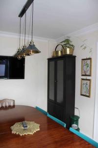 a dining room with a table and a black cabinet at Ivy House in Bangor