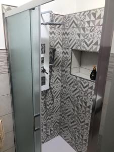 a shower with a glass door in a bathroom at Home Sulcitana in Elmas