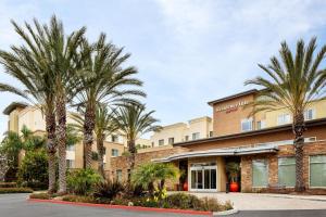 a rendering of the front of a hotel with palm trees at Residence Inn by Marriott Tustin Orange County in Tustin