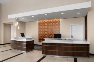 an office lobby with a reception desk and a wall at Residence Inn by Marriott Tustin Orange County in Tustin
