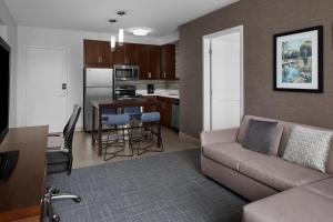 a living room with a couch and a kitchen at Residence Inn by Marriott Tustin Orange County in Tustin