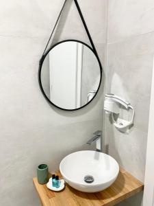 a bathroom with a white sink and a mirror at Villa Saral Mar in Sarandë