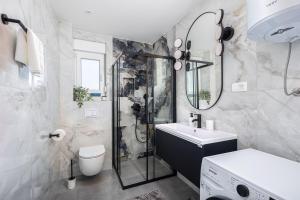 a bathroom with a shower and a sink and a toilet at Penthouse Apartments East and West Star in Kaštela