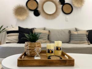 a living room with a tray with candles and a couch at Casa AMARE - Naxos in Naxos Chora